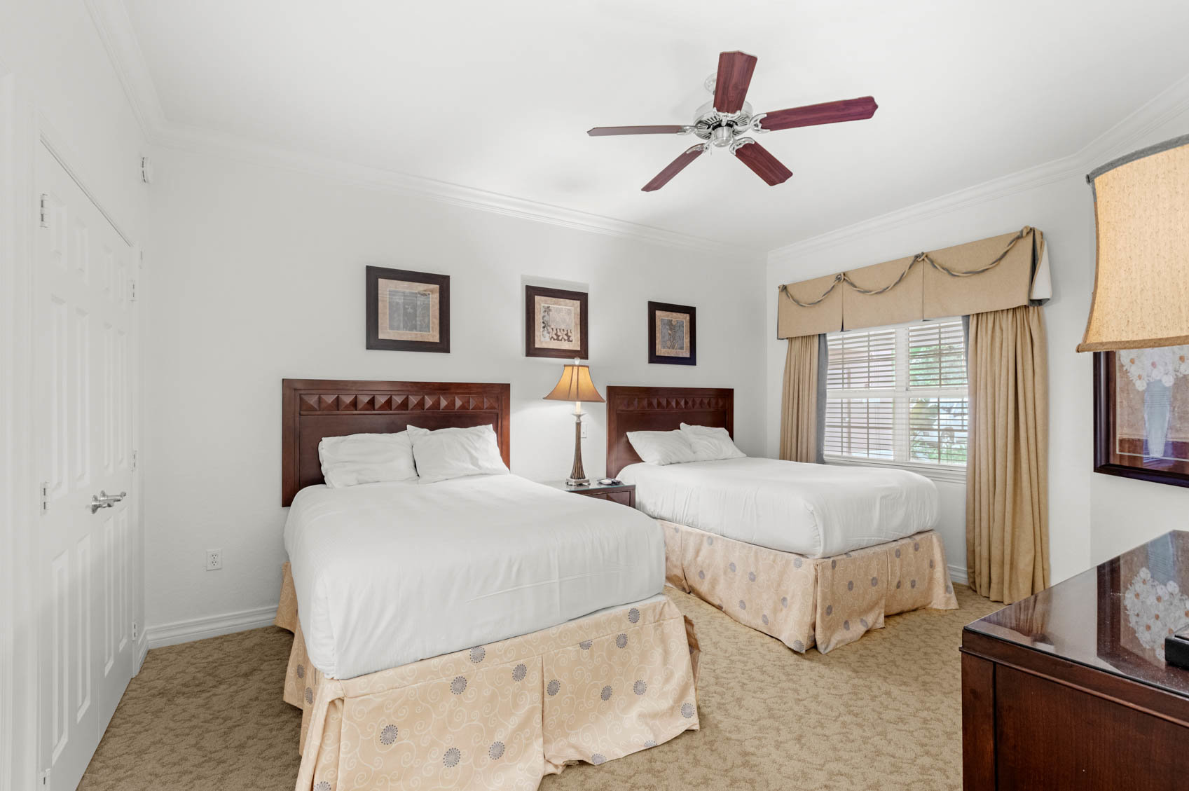 bedroom with two beds and white comforters